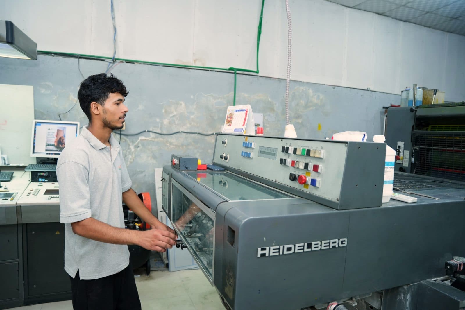 A press operator making ready on the Heidelberg offset press
